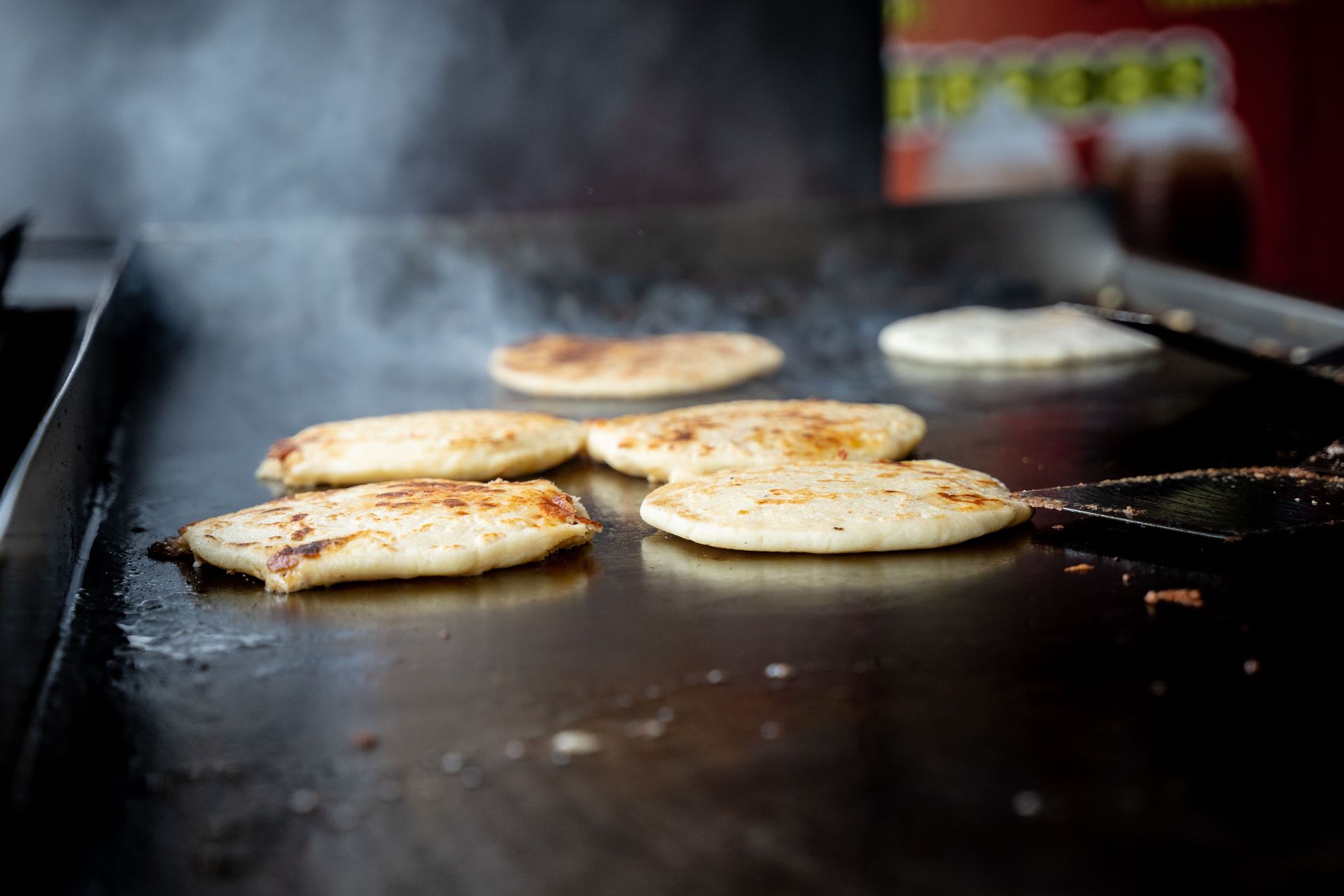 Freshly cooked flatbread sizzling on a hot grill, capturing the essence of street food.